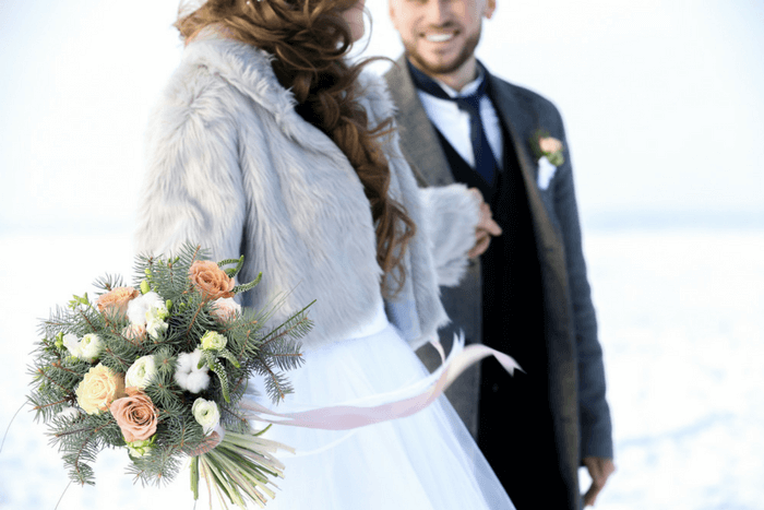 Сouple wearing a white gown and a black suit